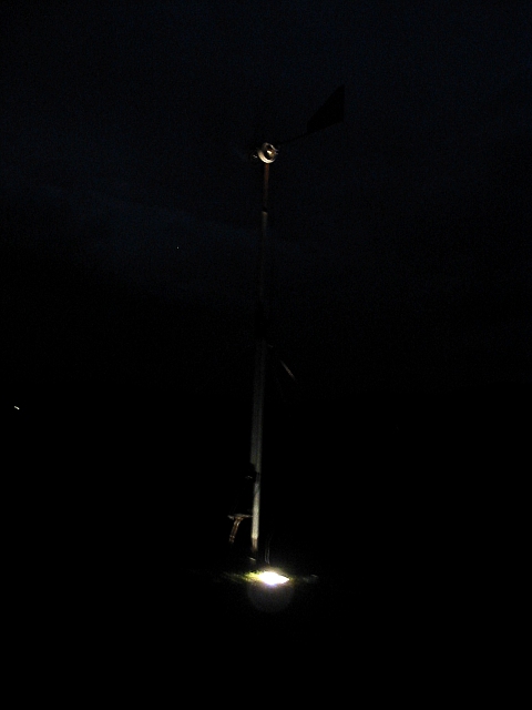 Big windmill during a very windy night. There are 3 100watt spotlamps 
